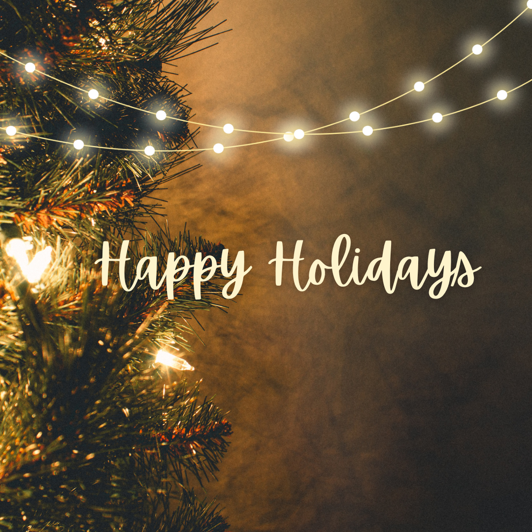 A christmass tree with shinning lights in the background written "Happy Holdays"